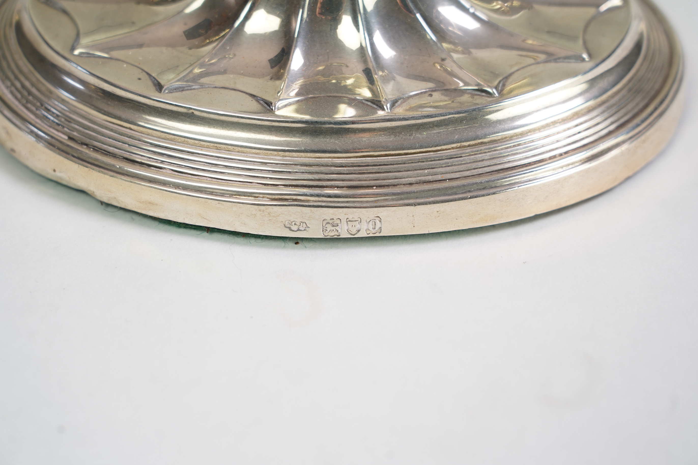 A matched set of four Edwardian fluted silver candlesticks, by Sibray, Hall & Co Ltd